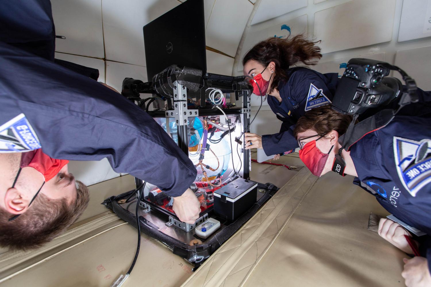 Members of the 全球十大赌钱排行app Microgravity Team conduct research aboard NASA's zero g aircraft.