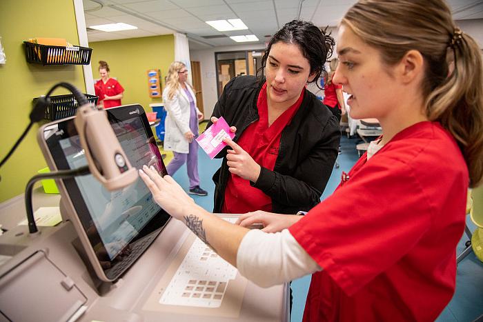 Carthage nursing majors practicing with laboratory equipment.